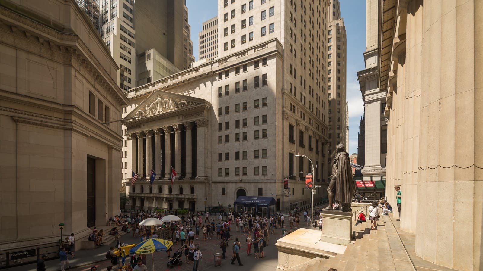 New York Stock Exchange facade and flags viewed from Broad Street