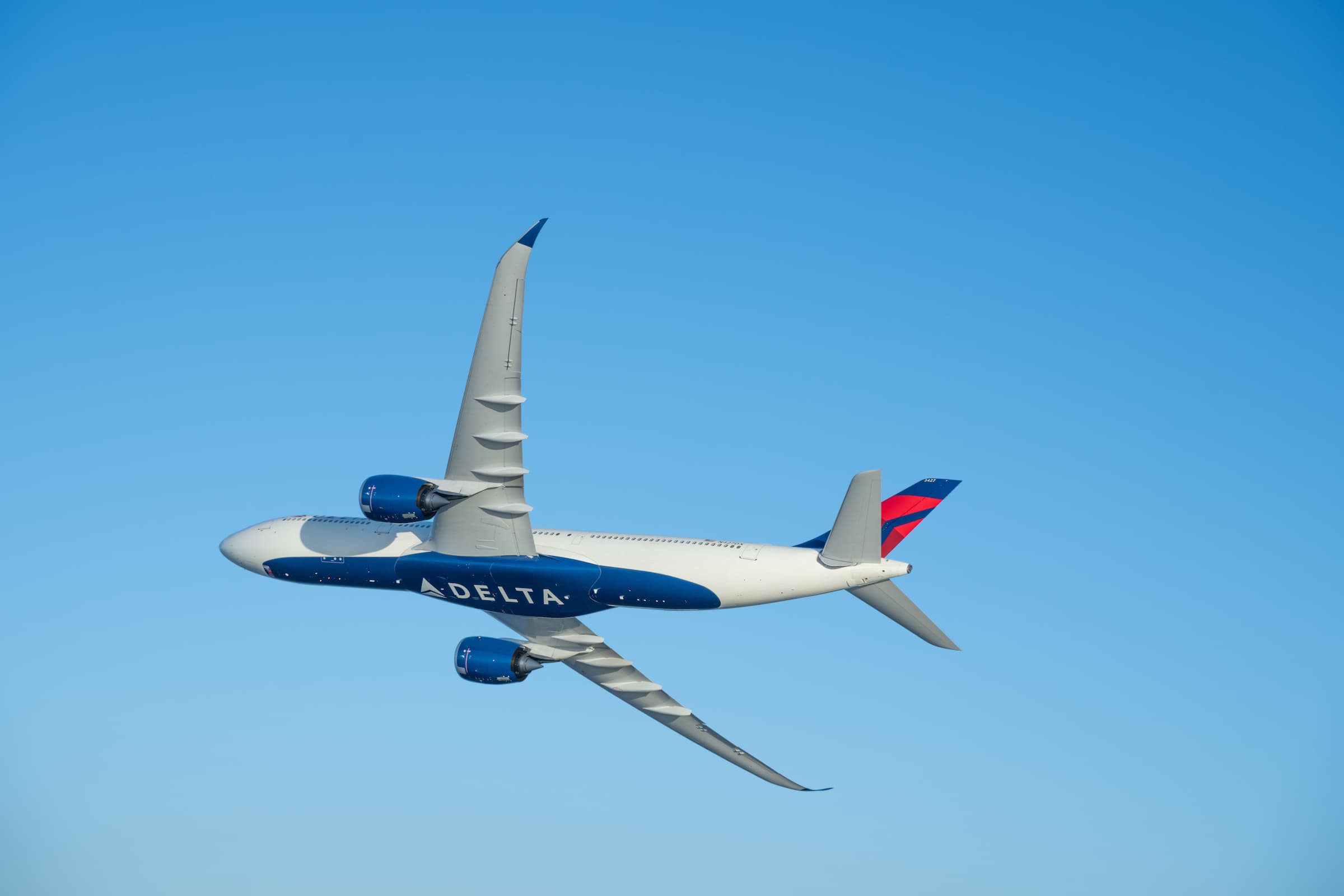 A Delta Air Lines aircraft in flight, the official image for the June-quarter 2026 results.