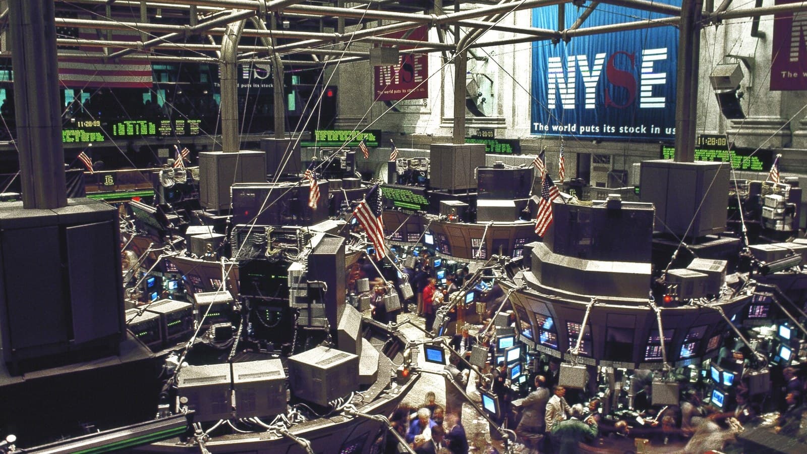 Traders work on the floor of the New York Stock Exchange in a documentary photograph
