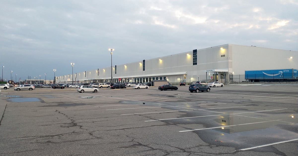 Amazon Fulfillment Centre YYZ4 in Brampton with parked cars and a Prime trailer.