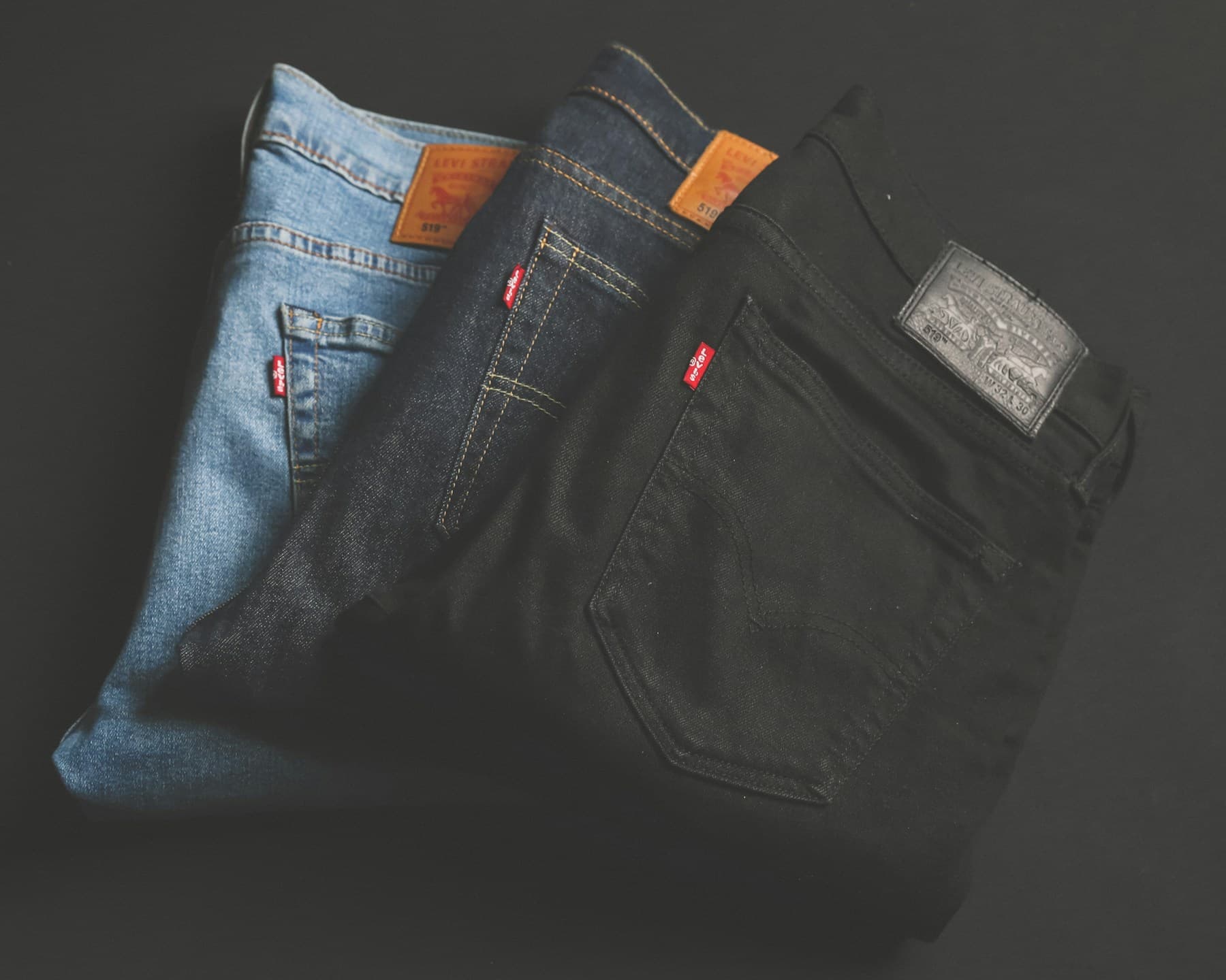 Folded blue denim jeans photographed in natural light.