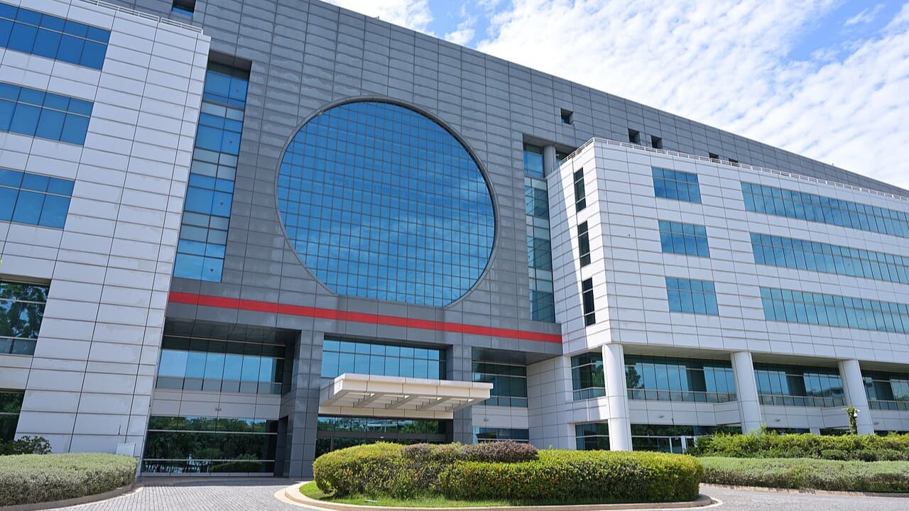 Exterior photograph of a semiconductor fabrication building in Tainan with a round wafer-shaped window