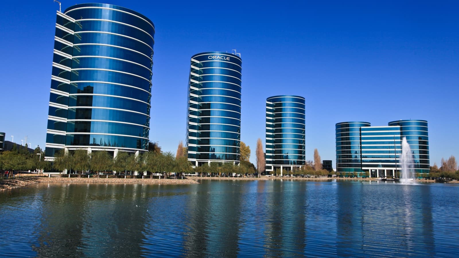 Oracle’s cylindrical headquarters buildings reflected in the lagoon at Redwood Shores, California