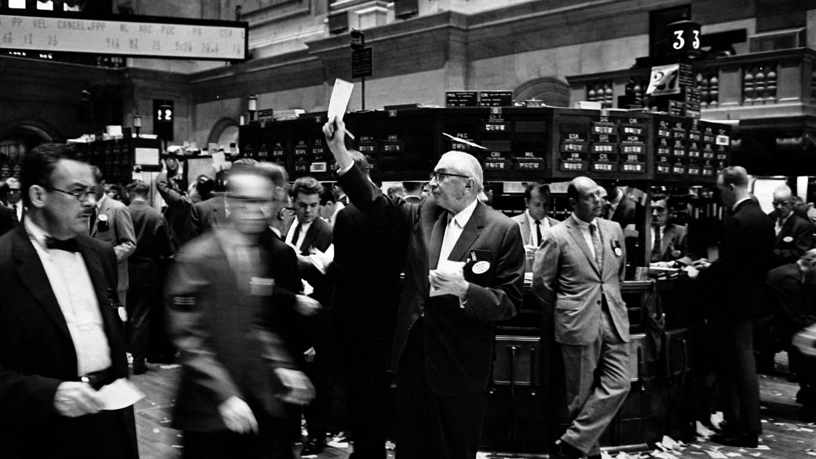 Stock brokers working on the New York Stock Exchange floor in 1963