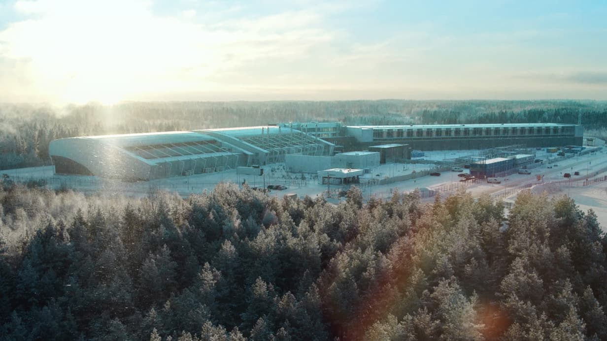 Nebius official data-center campus image in a snowy forest setting.