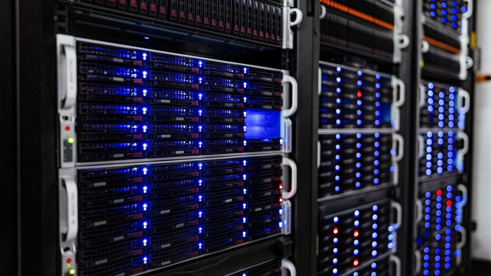 Illuminated server racks in a computer room, representing AI-cloud infrastructure
