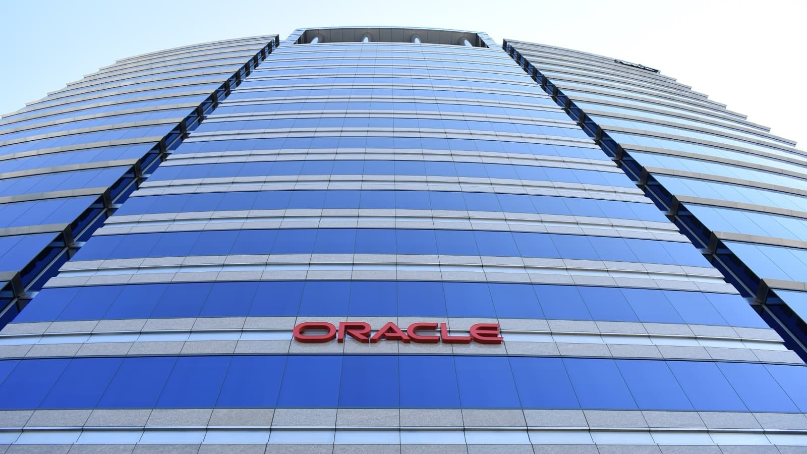 Low-angle photograph of the blue-glass Oracle Corporation building in San Jose