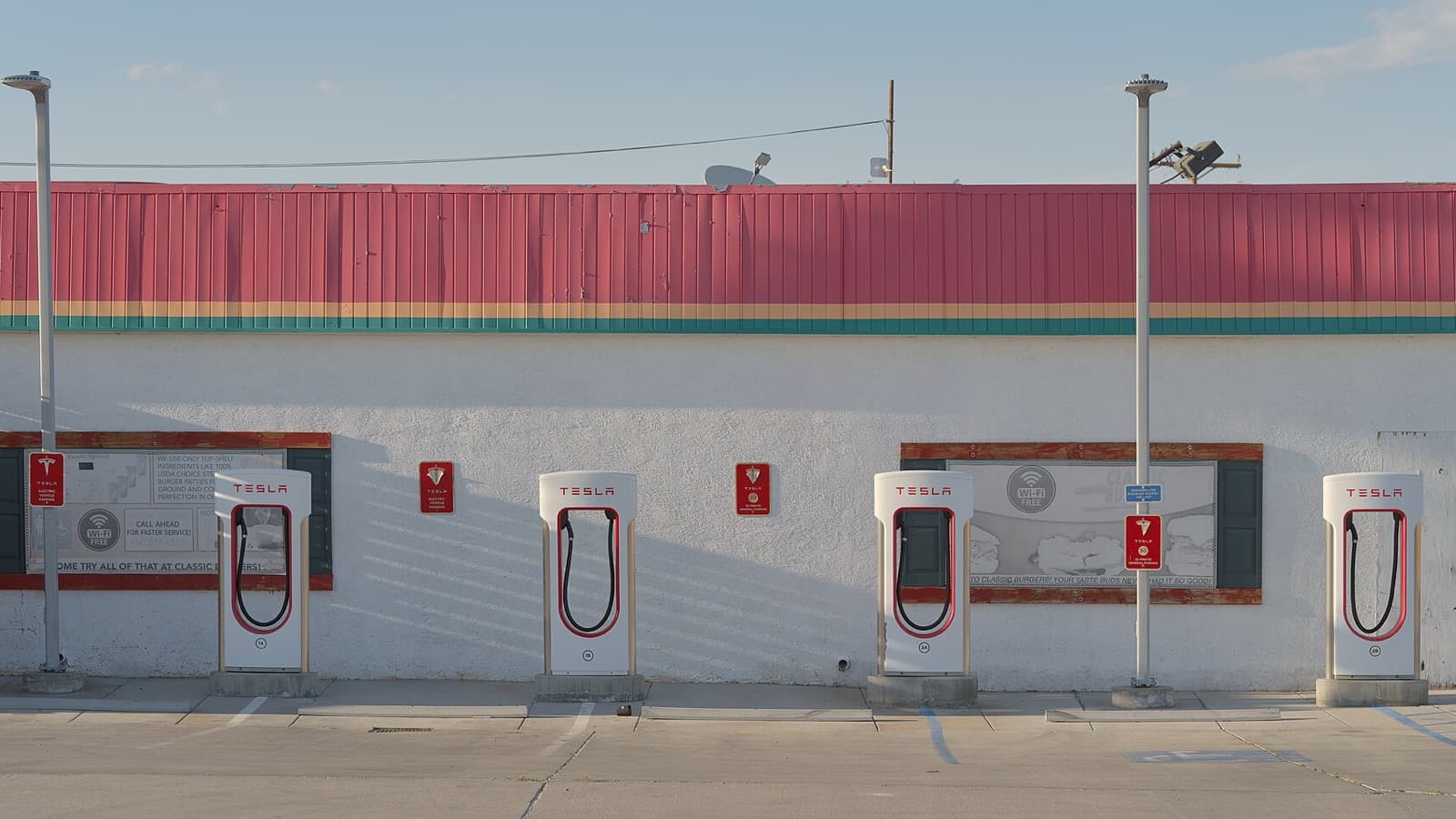 Four Tesla Supercharger stalls outside a roadside restaurant in Inyokern, California