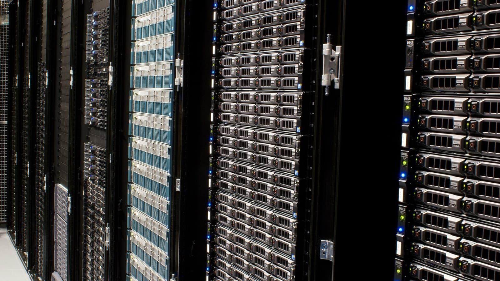 Rows of server racks in a working data center, representing onsite power demand