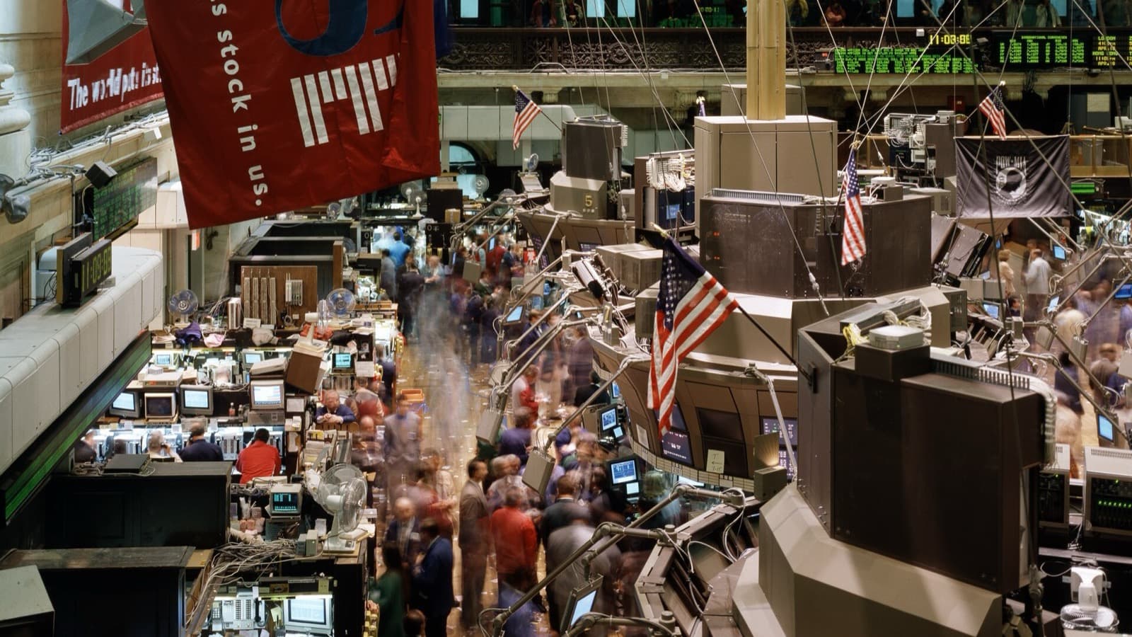 The New York Stock Exchange trading floor with traders and market screens