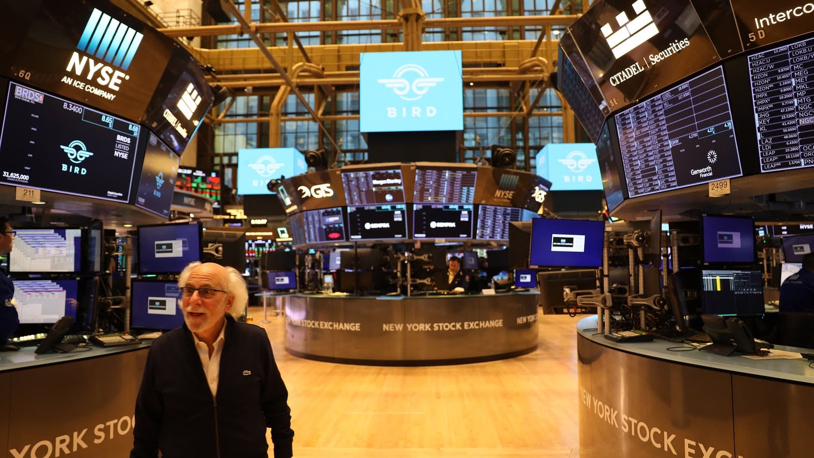 NYSE trader Peter Tuchman stands among trading desks and market screens on the exchange floor