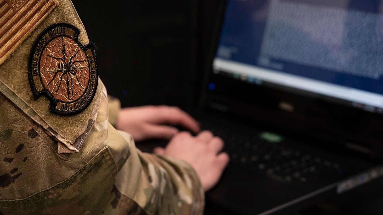 An Airman works on computer equipment inside a server room at RAF Lakenheath