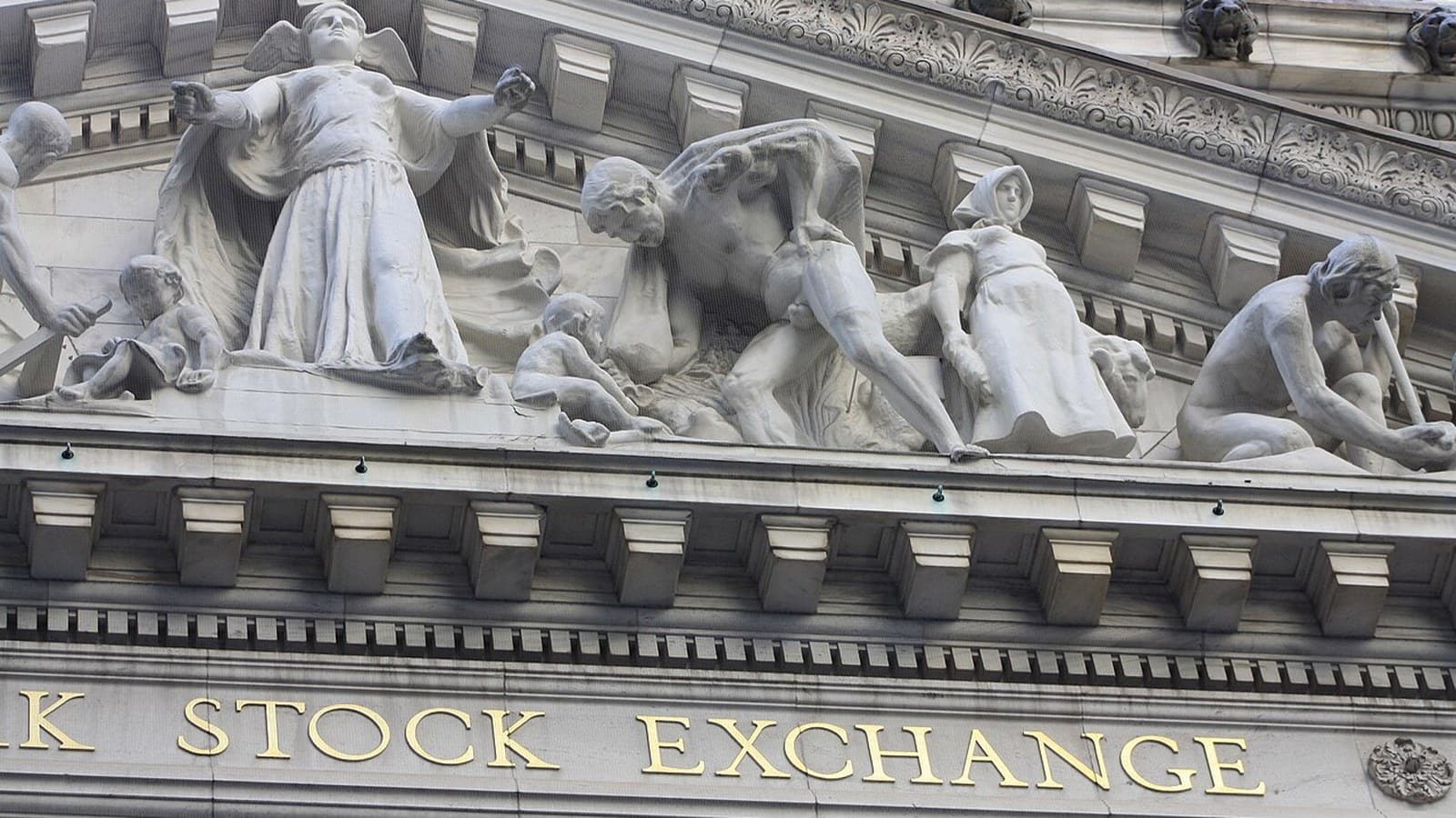 Stone sculptures and partial Stock Exchange lettering on the New York Stock Exchange facade