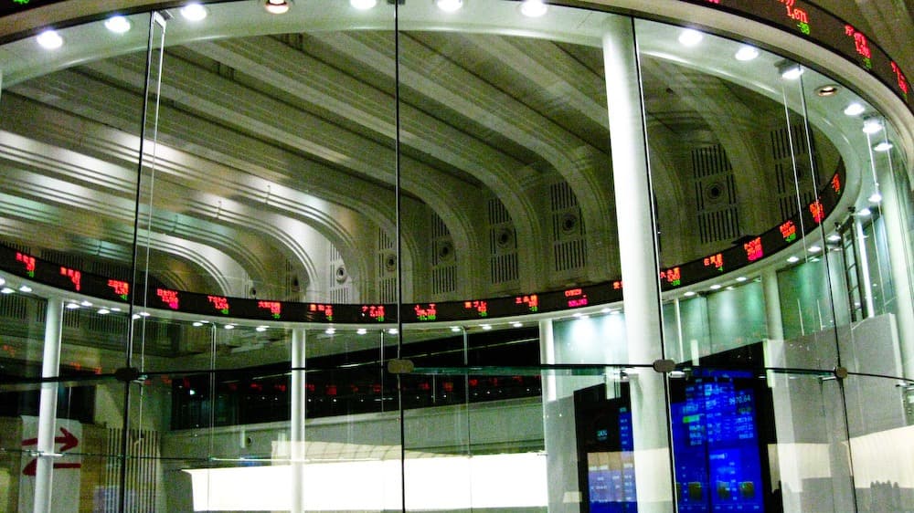 Electronic market tickers curve around the glass Market Centre inside the Tokyo Stock Exchange