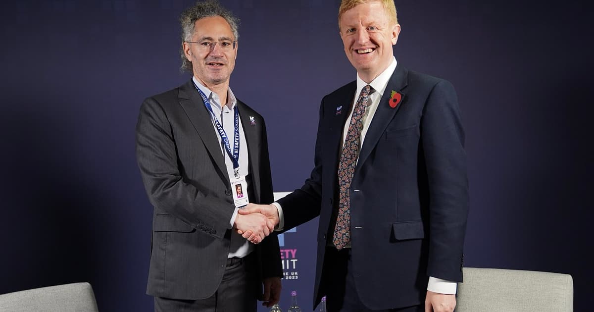 Palantir CEO Alex Karp and UK Deputy Prime Minister Oliver Dowden shake hands at the 2023 AI Safety Summit.