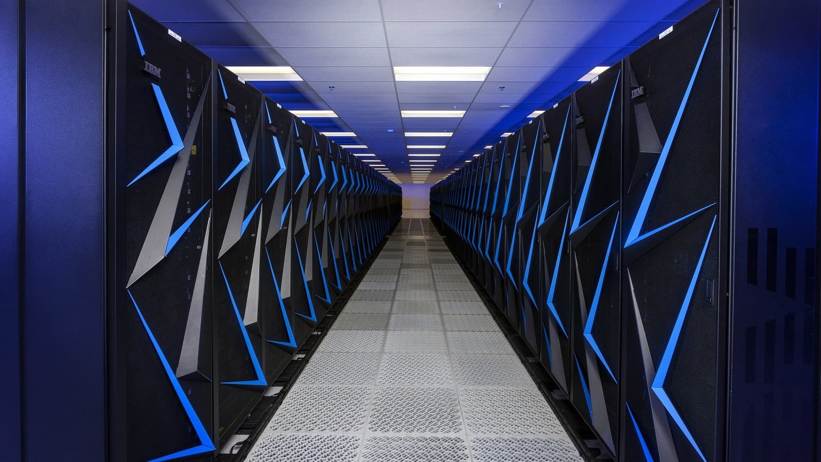 Rows of illuminated Sierra supercomputer cabinets inside Lawrence Livermore National Laboratory.