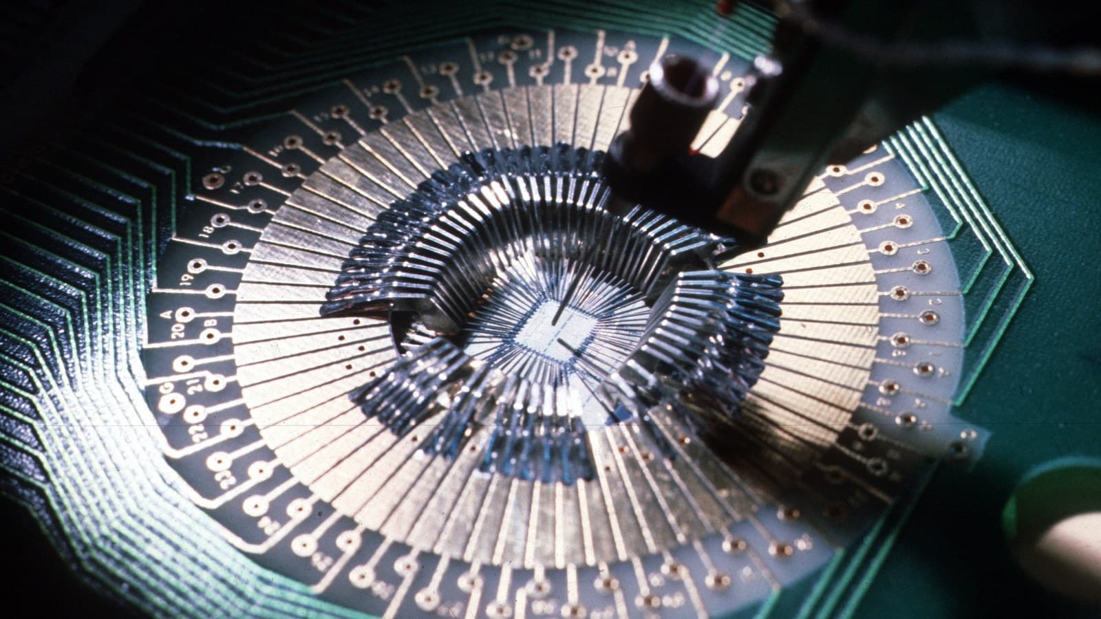 Mechanical probe testing a wired VLSI microchip during semiconductor manufacture