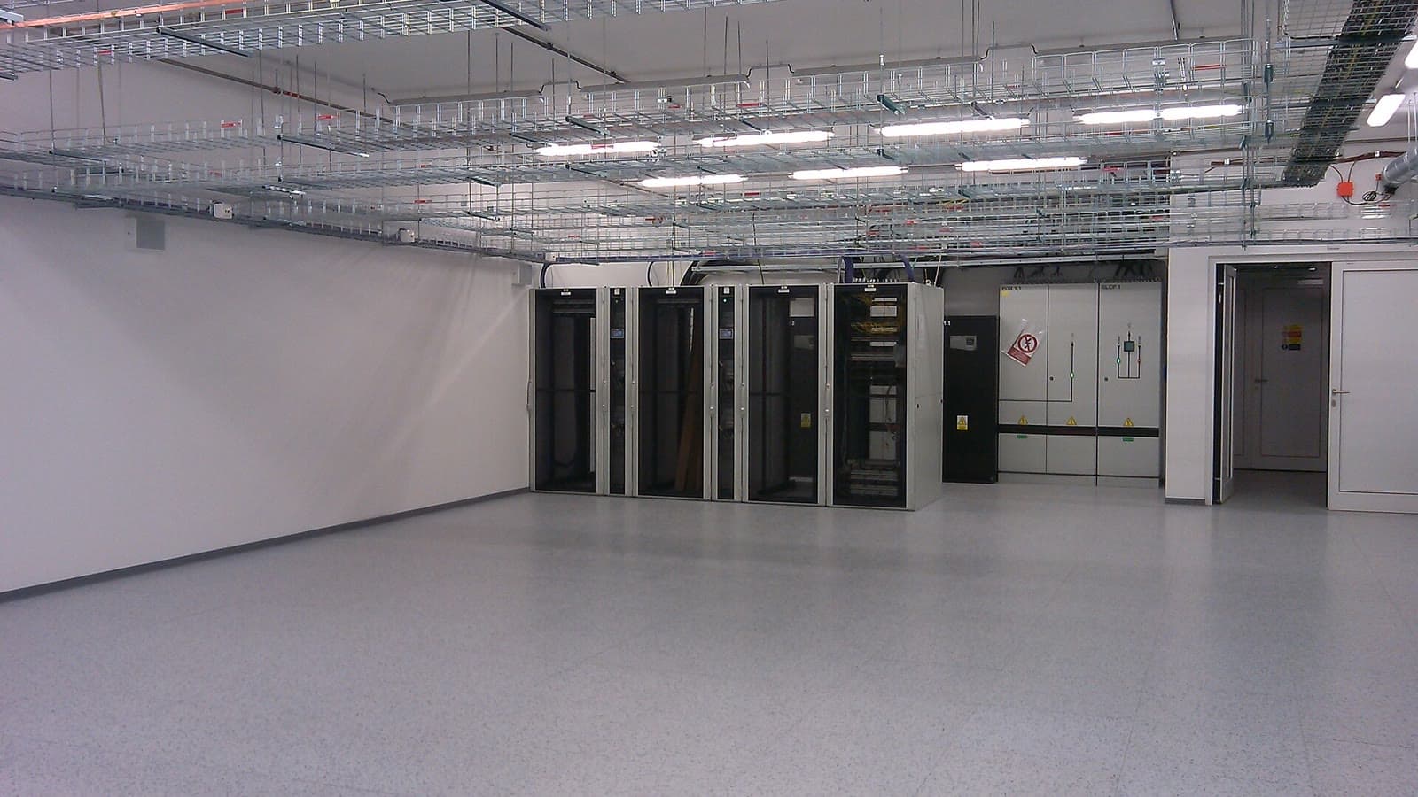 Server cabinets and overhead cable trays inside the CERIT data centre in Brno