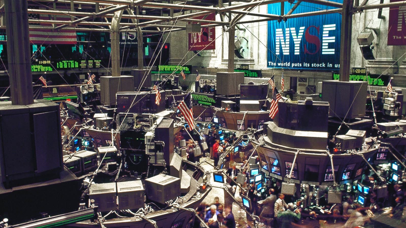 Stock brokers work across the New York Stock Exchange trading floor