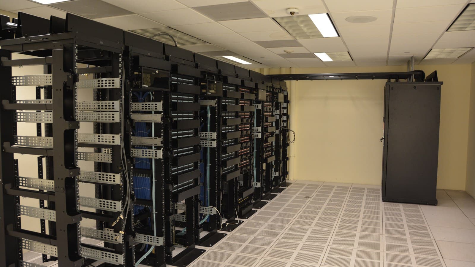 Archival networking racks and cabling in a data-centre equipment room; not a featured company facility