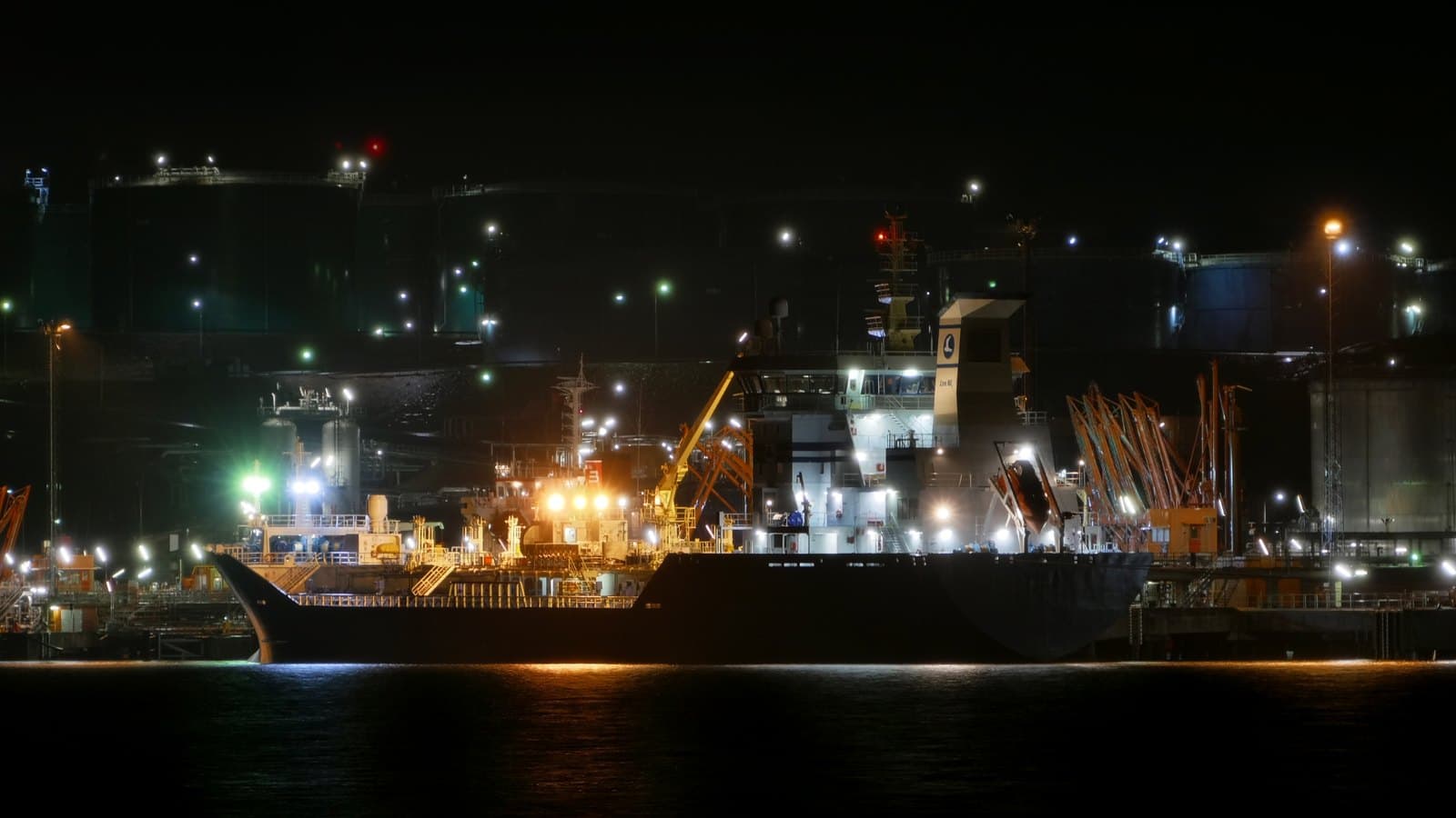 Tanker at the illuminated Preemraff Lysekil petroleum terminal in Sweden; archival oil-shipping photograph, not the Gulf
