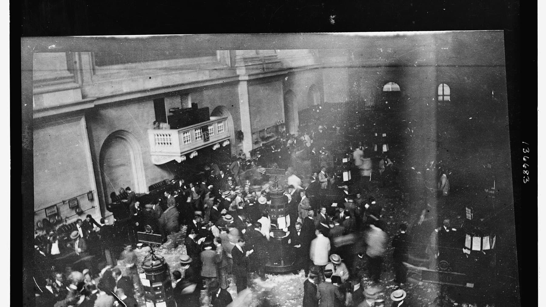 Black-and-white photograph of traders crowded on the New York Stock Exchange floor